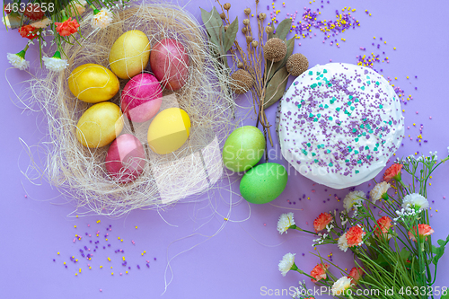 Image of composition of Easter eggs and cake on a purple background