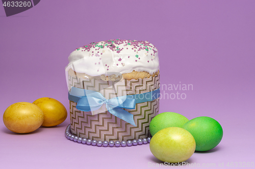 Image of Easter cake pattern with blue ribbon and yellow-green eggs