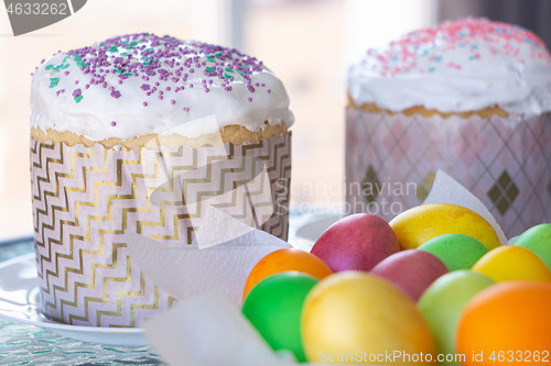 Image of Two Easter cakes and colorful eggs closeup