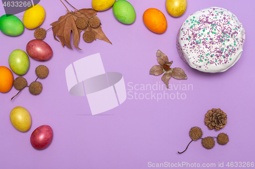 Image of location of Easter cake and painted eggs on a lilac background