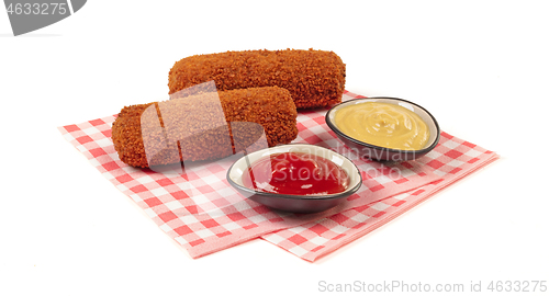 Image of Brown crusty dutch kroket with sauces (mustard and ketchup) isol