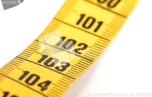 Image of Close-up of a yellow measuring tape isolated on white - 103