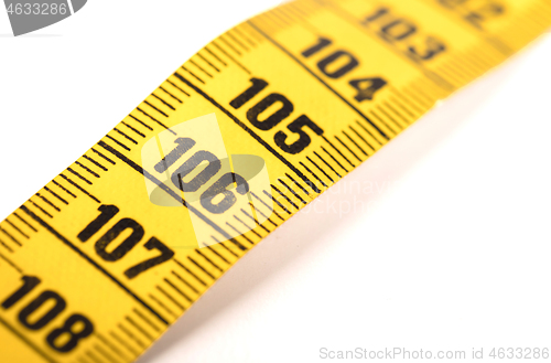 Image of Close-up of a yellow measuring tape isolated on white - 106