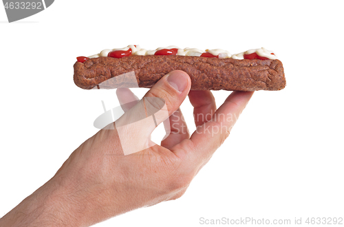 Image of One frikadel with ketchup, mayonnaise on chopped onions, a Dutch