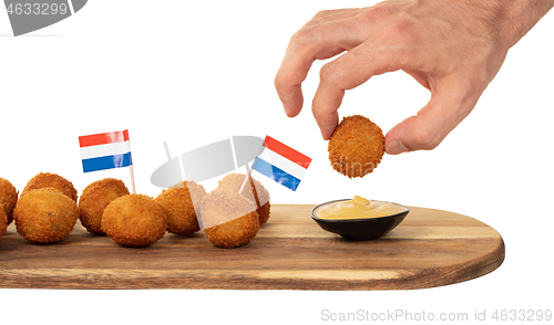 Image of Dutch traditional snack bitterbal in a hand