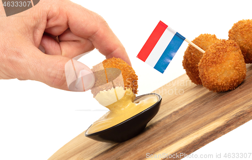 Image of Dutch traditional snack bitterbal in a hand