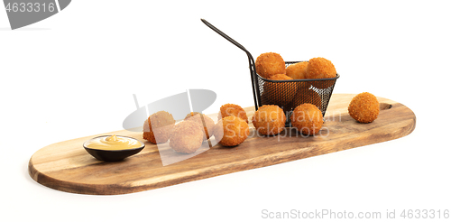 Image of Dutch traditional snack bitterbal on a serving board