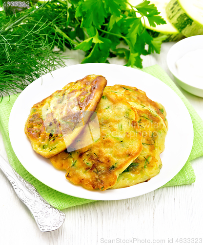 Image of Pancakes of zucchini on light wooden board