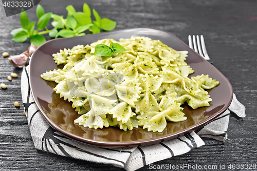 Image of Farfalle with pesto in plate on dark board