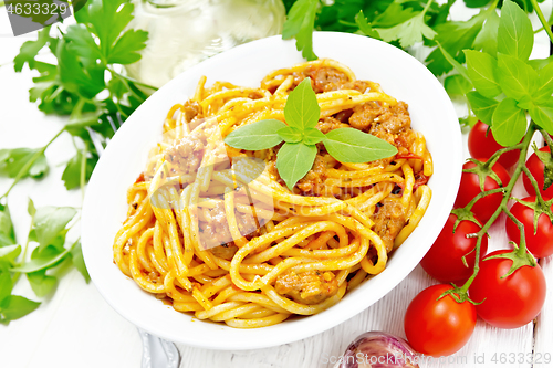 Image of Spaghetti with bolognese in plate on board