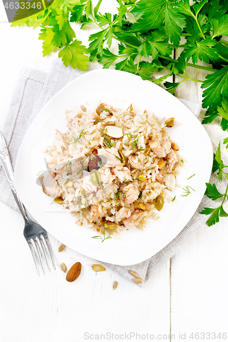 Image of Salad of salmon and rice in plate on light board top