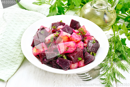 Image of Salad of beets and potatoes in plate on white board