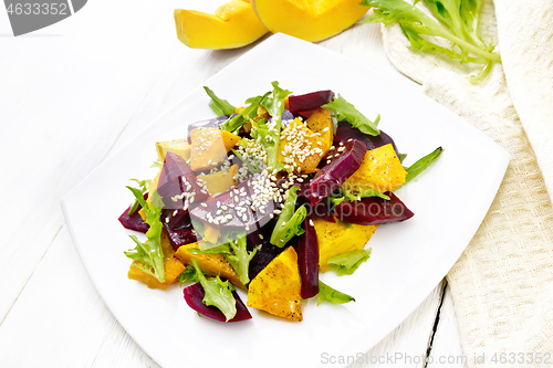 Image of Salad of pumpkin and beetroot in plate on white board