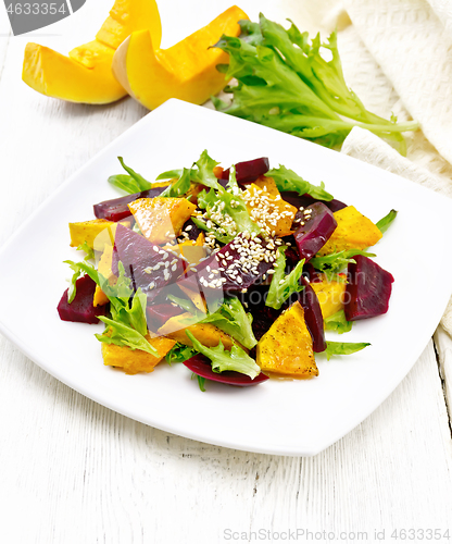 Image of Salad of pumpkin and beetroot in plate on wooden board