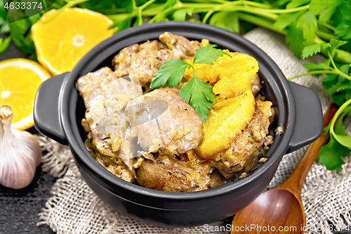 Image of Liver with oranges in pan on board