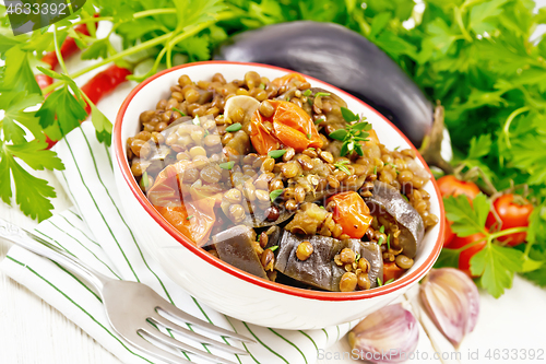 Image of Lentils with eggplant in bowl on white board