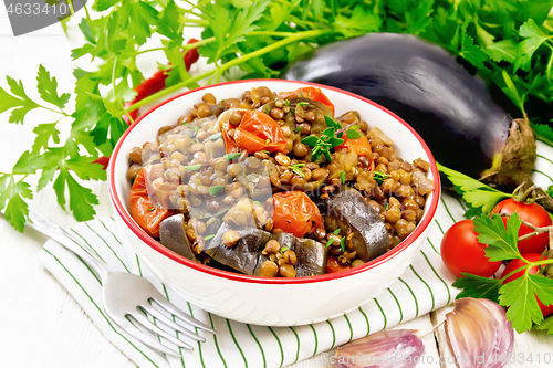 Image of Lentils with eggplant in bowl on napkin