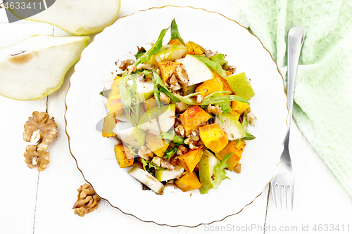 Image of Salad of pumpkin and pear in plate on board top