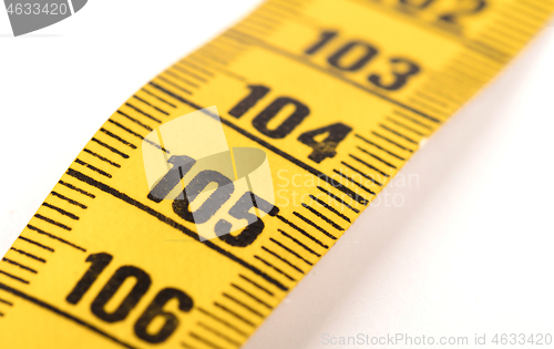 Image of Close-up of a yellow measuring tape isolated on white - 105