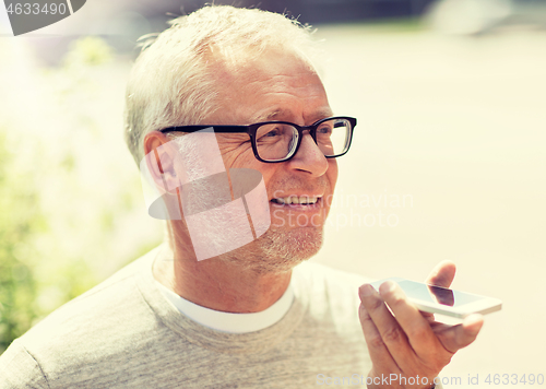 Image of old man using voice command recorder on smartphone