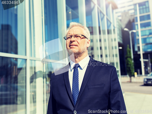 Image of senior businessman on city street