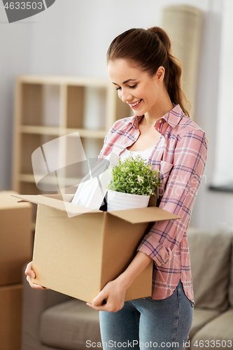 Image of happy woman with stuff moving to new home