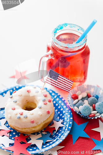 Image of donut with juice and candies on independence day