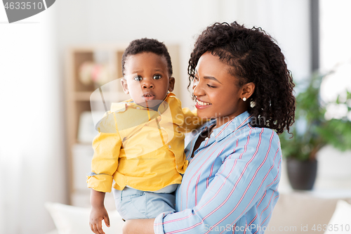 Image of happy african american mother with baby at home