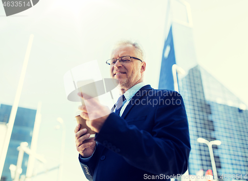 Image of businessman with smartphone and coffee in city