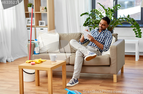 Image of indian man making to do list after home cleaning