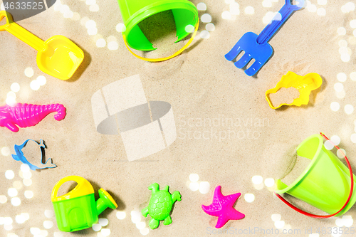 Image of close up of sand toys kit on summer beach