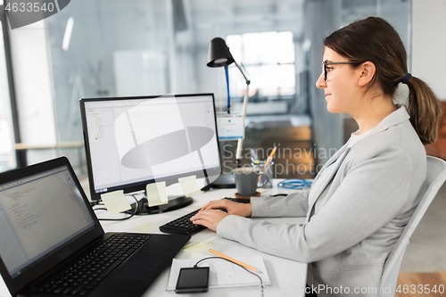 Image of businesswoman with computer working at office