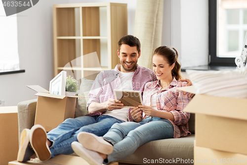 Image of happy couple with boxes moving to new home