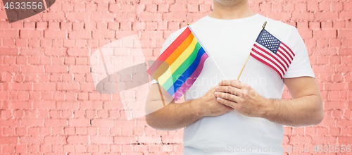 Image of man with gay pride rainbow flag and wristband