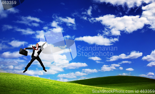 Image of Jumping business man on Green Field