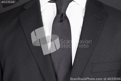 Image of Man in a black suit, close-up