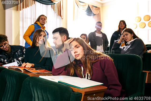 Image of The group of cheerful happy students sitting in a lecture hall before lesson