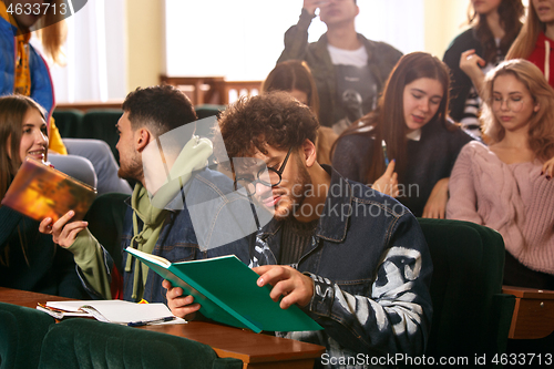 Image of The group of cheerful happy students sitting in a lecture hall before lesson