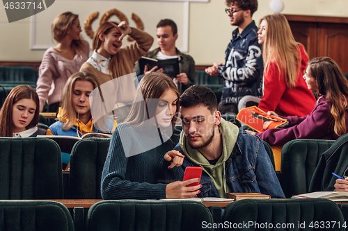 Image of The group of cheerful happy students sitting in a lecture hall before lesson