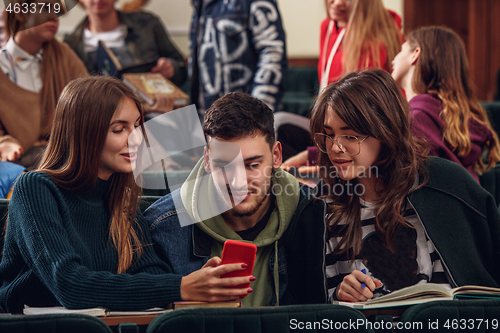 Image of The group of cheerful happy students sitting in a lecture hall before lesson