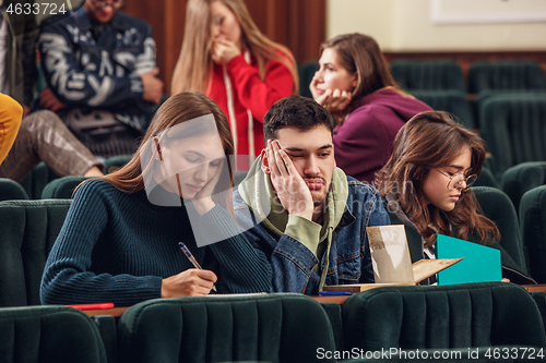 Image of The group of cheerful happy students sitting in a lecture hall before lesson