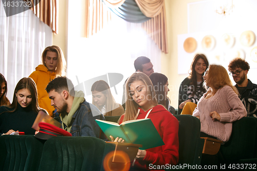 Image of The group of cheerful happy students sitting in a lecture hall before lesson