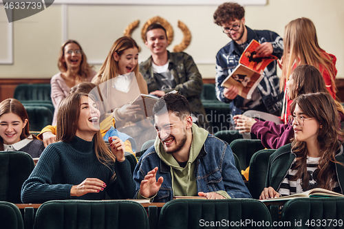 Image of The group of cheerful happy students sitting in a lecture hall before lesson