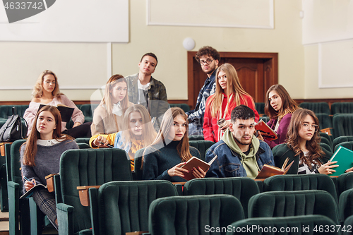 Image of The group of cheerful happy students sitting in a lecture hall before lesson