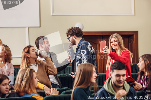 Image of The group of cheerful happy students sitting in a lecture hall before lesson