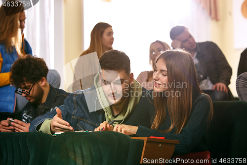 Image of The group of cheerful happy students sitting in a lecture hall before lesson