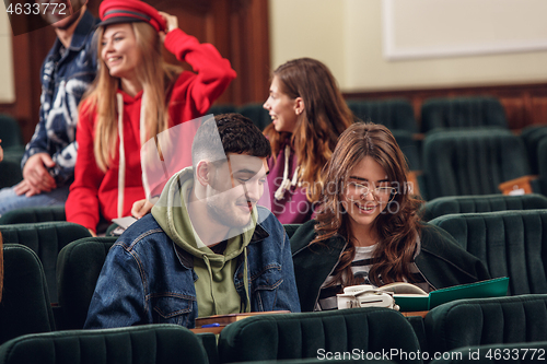 Image of The group of cheerful happy students sitting in a lecture hall before lesson