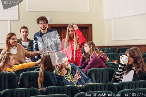 Image of The group of cheerful happy students sitting in a lecture hall before lesson