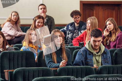 Image of The group of cheerful happy students sitting in a lecture hall before lesson