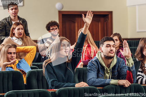 Image of The group of cheerful happy students sitting in a lecture hall before lesson